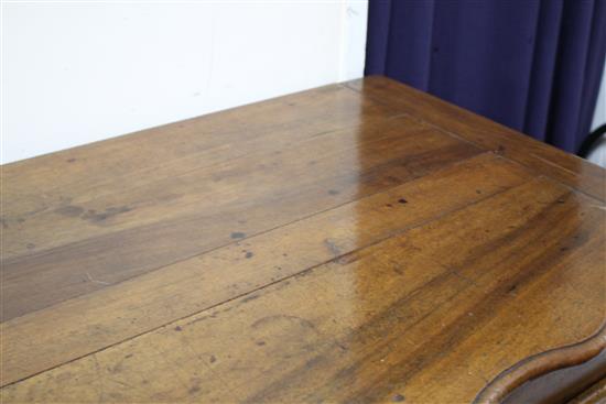 An 18th century French provincial walnut cabinet, with serpentine top and two panelled doors, W.138cm D.63cm H.95cm